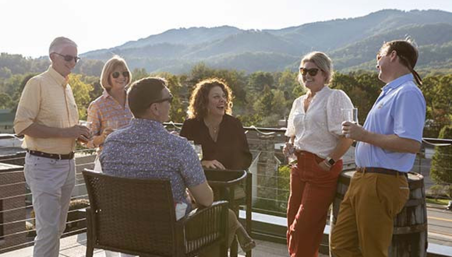 couples laughing on rooftop deck at the schoolhouse hotel wv