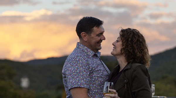 couple on rooftop at schoolhouse hotel near sunset