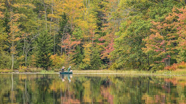 two fisherman in a canoe on summit lake wv